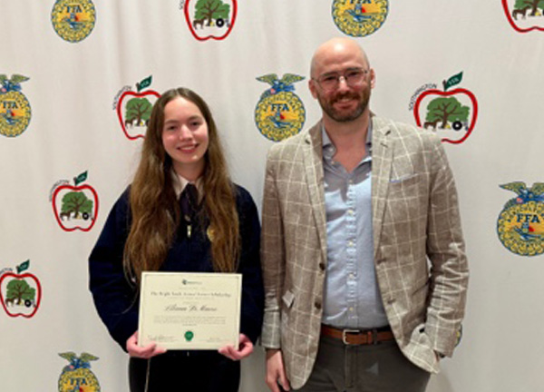 Liliana DiMauro, Southington High School student, receives the Bright Feeds Animal Science Scholarship certificate at an FFA ceremony in Southington, CT.
